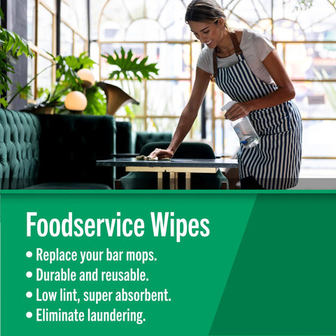 Foodservice wipes banner in cafe; green banner, woman in striped apron wipes a table with a spray bottle.