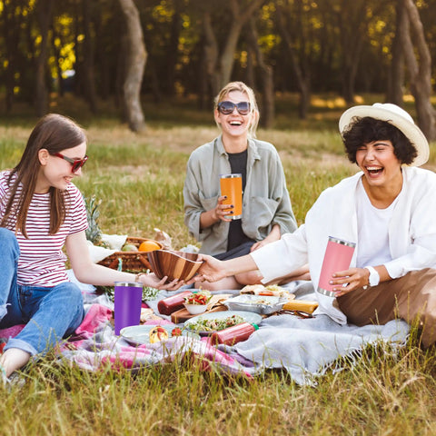 Group enjoying a picnic with a 20 Ounce Stainless Steel Tumbler With Secure Lid Pink Insulated Coffee Cup.