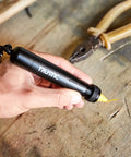 Hand holding Heavy Duty Lumber Crayon Holder for 1/2 Inch Round or Hex Crayons, Beefy Industrial Metal Carpenter Tool with black grip.