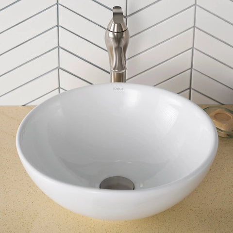 Elavo Round Vessel White Porcelain Ceramic Bathroom Sink 16 Inch for Modern Bathrooms on beige countertop with faucet