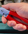 Person holding Heavy Duty Hog Ring Pliers With 3/8 Stainless Hog Rings Spring Loaded Jaws PVC Grips 7 Inch Auto Upholstery Tool