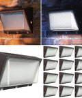 12 Pack 120W LED Wall Pack Outdoor Dusk To Dawn Photocell Security Lighting illuminated and in daylight, shown in multiple units.