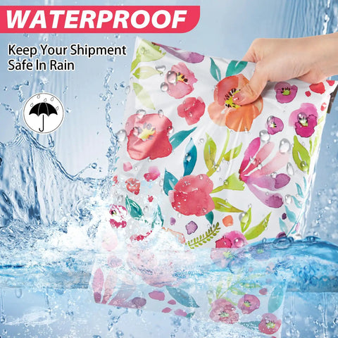 Hand holding a waterproof 6x9 floral poly mailer demonstrating durability under water spray, Durable 6x9 Floral Poly Mailers 100 Pack For Shipping Waterproof Tear Resistant Mailing Bags Easy Seal Envelopes For Small Biz Lightweight Packaging Bags That Stand Up To Rough Transit