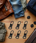 6 Pack Black Detachable Zipper Pull Replacements Kit for Jackets, Pants, Coats, Shoes, Bags, and Luggage on a wooden table.