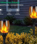 43 Inch Tall Solar Torch Lights With Realistic Flickering Flames 96 LED Outdoor Yard Patio Christmas Decor 4 Pack IP65 Weatherproof Solar Powered Dusk To Dawn Auto On Off For Safe Easy Outdoor Ambience And Walkways glowing in garden