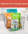 Industrial Gray Utility Basket With Easy Grip Handles For Kitchen Pantry Organization And Closet Shelf Bins Durable Steel Wire Container Open Grid Design Heavy Duty Shelving Essential Modern Home Vibes with snacks inside on countertop.