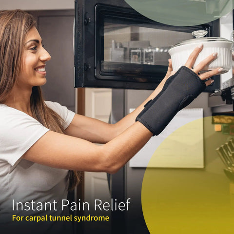 Person wearing a Nighttime Carpal Tunnel Wrist Brace With Cushioned Bead Palm Pillow For Tendonitis And Arthritis Pain Relief Lightweight Sleep Support Splint For Pregnancy Hand Comfort And Everyday Use, holding a pot near the microwave.