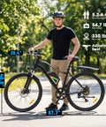 All Terrain Electric Mountain Bike With 1000W Peak Power, 20 mph Top Speed, adult standing beside 26 inch wheels, outdoor setting