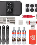 Grab-And-Go 8-In-1 Bike Repair Kit With CO2 Inflator And Cartridges, Saddle Bag, Tire Patch Kit And Levers laid out on white background