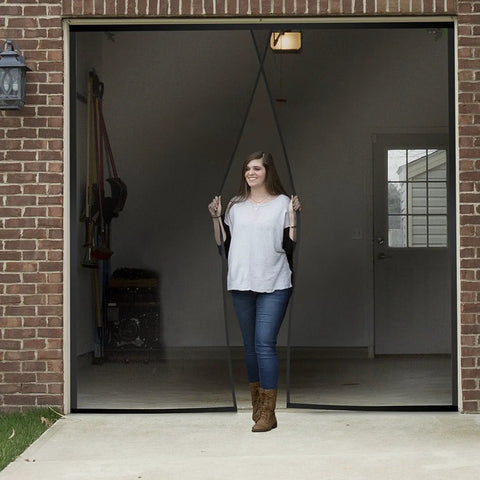 Woman demonstrating Heavy Duty Garage Door Screen With Magnetic Closure, Weighted Mesh Curtain Keeps Out Mosquitoes And Bugs.