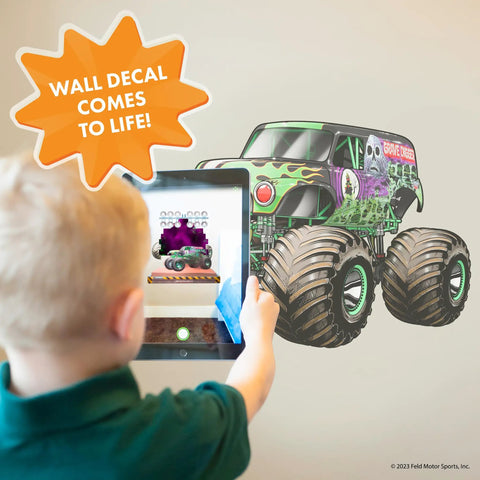 Child interacts with Grave Digger Monster Jam Wall Decal With 3D Augmented Reality Interaction Peel And Stick 28 Inch Epic Wall Decor.