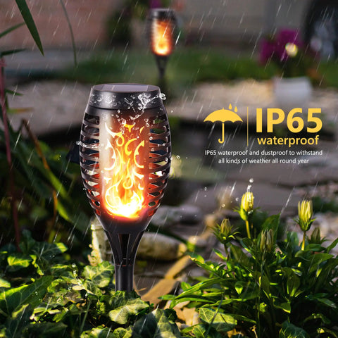 12 Pack Solar Torch Lights With Flickering Flames For Outdoor Use, waterproof lights installed in garden setting