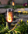 Six Pack Solar Torch Lights With Realistic Flickering Flame Dope Waterproof Outdoor Landscape Pathway Lights glowing in rain