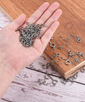 Top Shelf 304 Stainless Steel Eye Screws held in a hand, mini eye pins for DIY crafts and jewelry making.