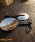 Pair of 16 Gauge Steel Rondels With Genuine Leather Straps for Elbows and Knees Armor on a leather surface in sunlight