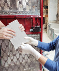 Person handing over white poly mailer envelopes 16x22 inches self sealing shipping bags waterproof tear resistant for packaging