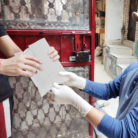 Person handing over white poly mailer envelopes 16x22 inches self sealing shipping bags waterproof tear resistant for packaging