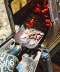 Heavy Duty Ash Shovel For Fire Pits And Grills, Manganese Steel Ember Remover 12.6 Inch Wood Stove Scoop in use with glowing embers