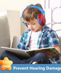 Child reading while wearing Kids Noise Canceling Headphones With Hearing Protection For Ages 3 To 15 Red Monster Jam style.