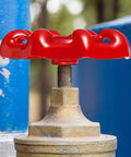 Red Cast Iron Valve Hand Wheel Set on industrial valve with decorative metal accents and flat bottom design