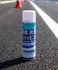 Uonlytech Reflective Hazard Marking Spray, Industrial Safety Warning Paint in 700ml can on asphalt road surface.