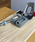 Twin Pocket Hole Jig Set With Adjustable Base And Magnetic Quick Adjust System in use on wooden board for woodworking joints