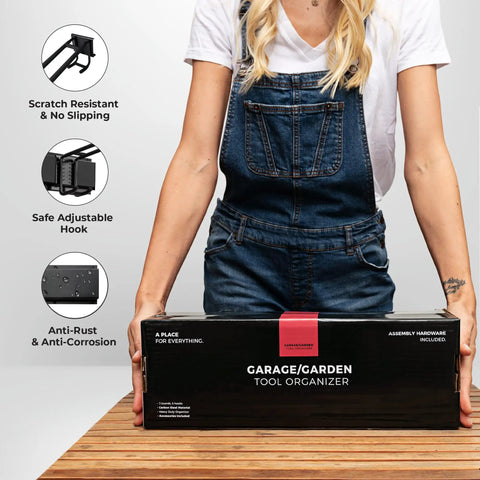 Person holding box of Beefy Garage Wall Organizer With Dual Layer Hooks, 48 Inch Carbon Steel Tool Rack, 300 Lb Capacity
