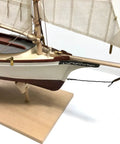 Close-up of the wooden ship model from Shipwright Series 3 Kits Trio with tools for adults, showcasing detailed mast and sails.