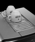 Top Tier Heavy Hitter Italian Fully Automatic Espresso Machine With Brushed Stainless Steel Housing, two white cups on top.