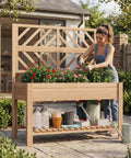 Person gardening in a Wooden Elevated Garden Bed With Trellis On Sturdy Legs Free Standing Planter Box With Storage Shelf 47 By 24 By 55 Inches Space Saving Design For Flowers Herbs Veggies And Climbing Vines On Patios And Balconies