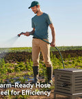 Man watering garden with Heavy Duty Hose Reel With Never Leak System Metal Deck Box Hideaway For 125 Feet 5 8 Inch Hose Manual Crank