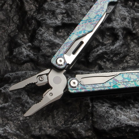 Camouflage Titanium Multitool Pliers Built Beefy With 420 Stainless Plier Head And 440 Steel Accessories on black rock