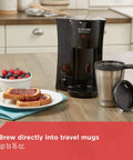 On The Go Personal Coffee Maker Brews 15 Ounces Directly Into A Stainless Steel Travel Mug with toast and berries on the side