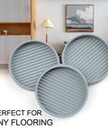 Image of three gray 3-inch round rubber furniture caster cups for beds and couches, non-slip pads for all floor types.