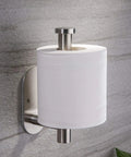 Stick On Toilet Paper Holder No Drilling Stainless Steel Brushed Finish Easy Install For Bathroom Bedroom and Lavatory Durable SUS 304 Roll Holder Six Point Two Inch Long Two Point Six Inch Plate with toilet paper roll mounted on gray wall.