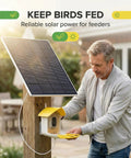 Man installing Outdoor Solar Panel Charger For Security Cameras, 3W USB C And Micro USB Ports on bird feeder