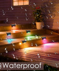Solar Pool Side Lights 4 Pack Color Changing Waterproof LED Deck Lights illuminating stairs at night with colorful glow