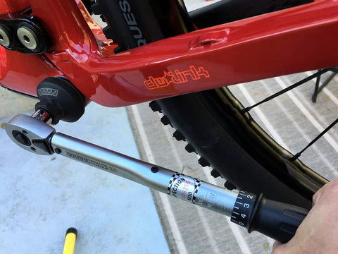 Torque wrench adjusting bike with External Bottom Bracket Socket For 16x44 16 Notch Cups And Disc Brake Lockrings drive tool.