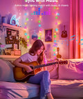 Woman playing guitar with App Controlled Curtain String Lights With 400 LED Pixel Art And Text Creator, music sync feature in room.