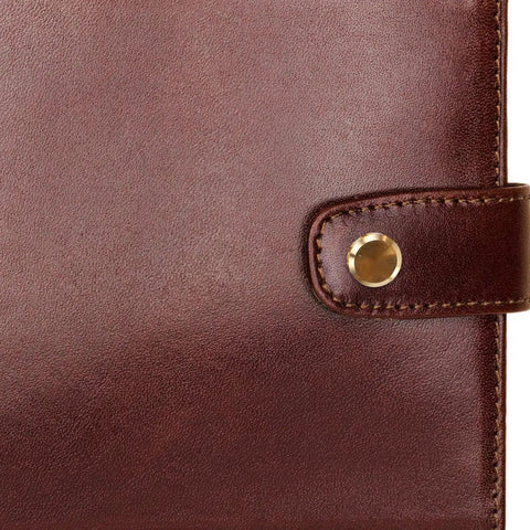 Close-up of brown leather cover with golden copper binding screw from 10 Piece Set Of Golden Copper Binding Screws For Scrapbooking And Bookbinding Projects Heavy Duty Craft Rivets That Knock It Out Of The Park Solid Build For Journal Assembly And Purse Crafting Vintage Hardware Setup Gonna Love This.