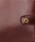 Premium Copper Binding Screw Posts on a rich brown leather cover, enhancing office documents with a sleek finish.