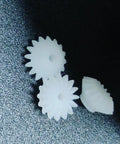 Dope Ten Piece Bevel Gear Set 0.5 Module 16 Teeth 1.9mm Bore 2mm Tight Fit Plastic S162A Bevel Gears close-up on textured surface.