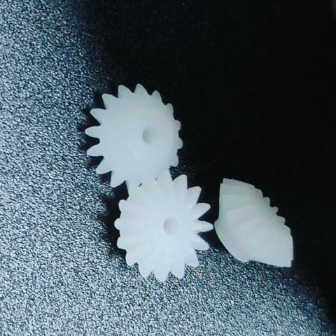 Dope Ten Piece Bevel Gear Set 0.5 Module 16 Teeth 1.9mm Bore 2mm Tight Fit Plastic S162A Bevel Gears close-up on textured surface.