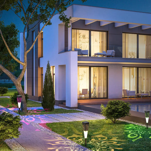 Modern house at night with Solar Powered Pathway Lights 4 Pack Multicolor Outdoor Garden Lights IP67 Waterproof illuminating walkway