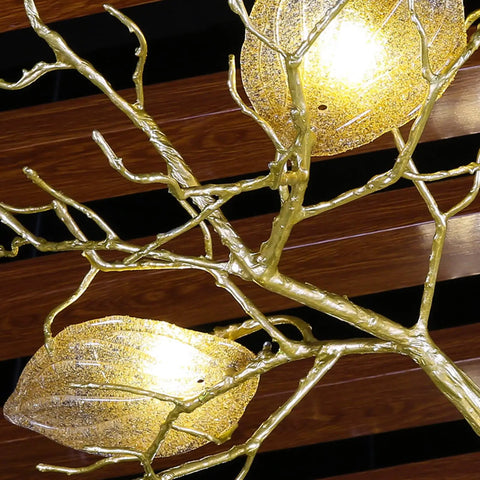 Make Your Spot Hit Different With This Top Notch Nine Light Art Branch Ceiling Pendant Light Featuring Chinese Zen Inspired Hanging Design And Durable Metal Build. Close-up of gold metal branches with glowing glass light shades.