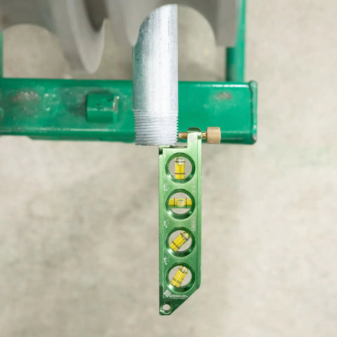 Mini Magnetic Bubble Level With Conduit Bending Offset Aid Four Large Vials attached to metal pipe on workbench
