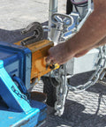 Man securing trailer with Six Pack Weld On Grab Hooks Three Eighths Inch Tow Chain Hooks G70 Forged Clevis Weldable Hooks