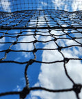 Close-up of Batting Cage Net For Baseball And Softball Practice, HDPE Netting With 42 Twine against blue sky background.