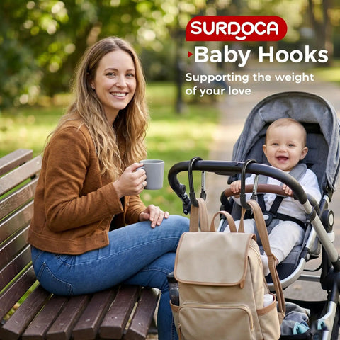 Woman with stroller and heavy duty stroller hooks for bags and gear, baby smiling, park setting, universal clips attached