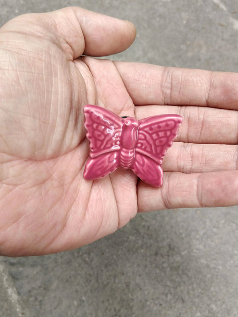 Ceramic Butterfly Cabinet Knobs Set Pink, 6 Pack Vintage Drawer Pulls, single knob held in hand showing details.